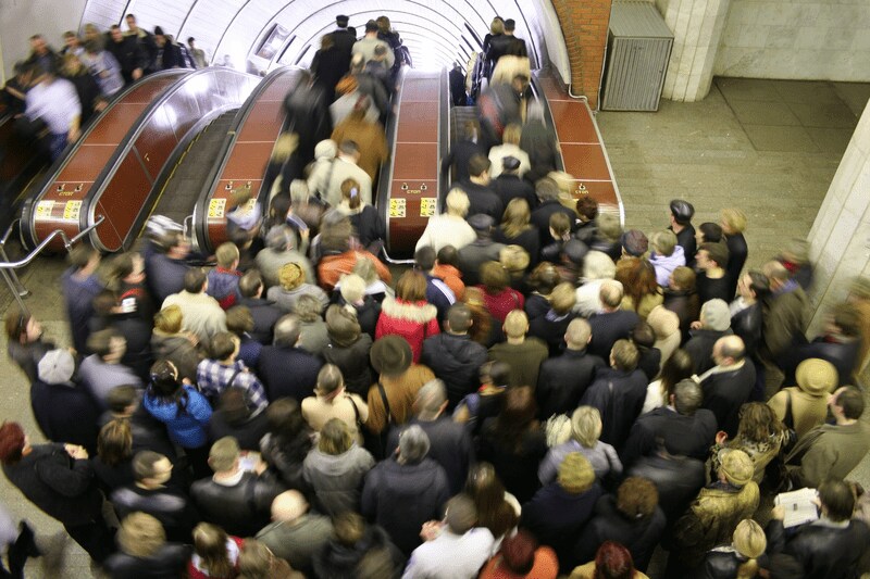 People walking down an escalator